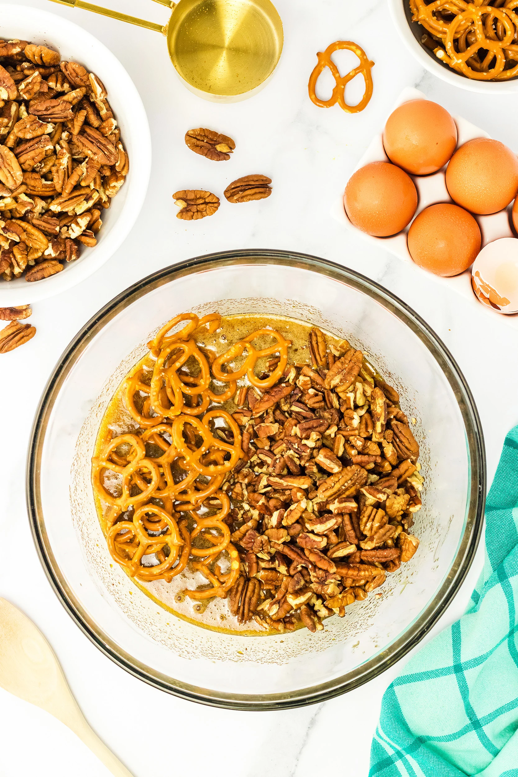 pretzels and pecan pieces added to the pie mixture, in a clear bowl