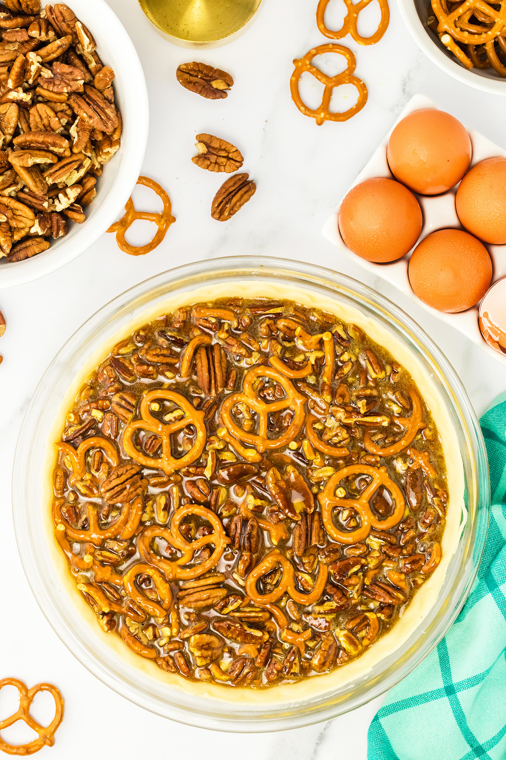 unbaked pretzel pecan pie on a marble slab