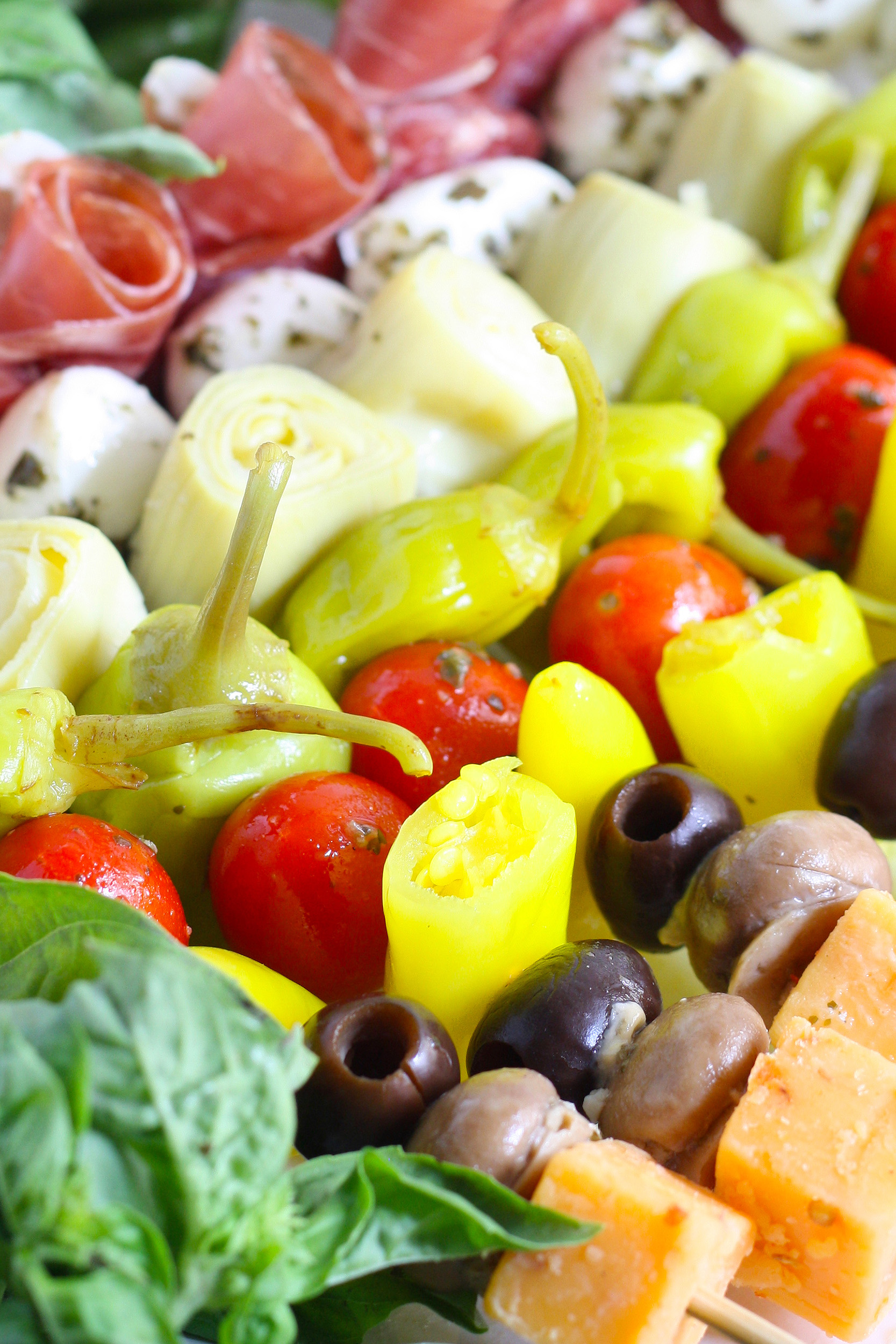 antipasto skewers with marinated ingredients, peppers, meat, and cheese