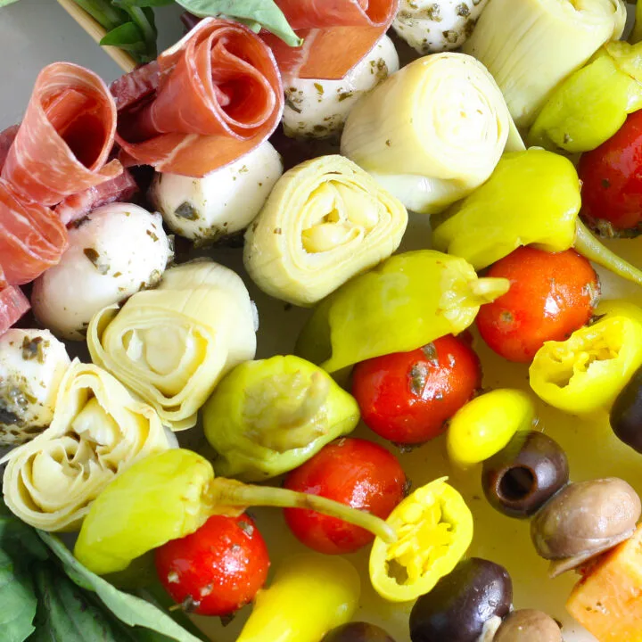 antipasti skewers with marinated ingredients like mushrooms and artichokes, peppers, meat, and cheese