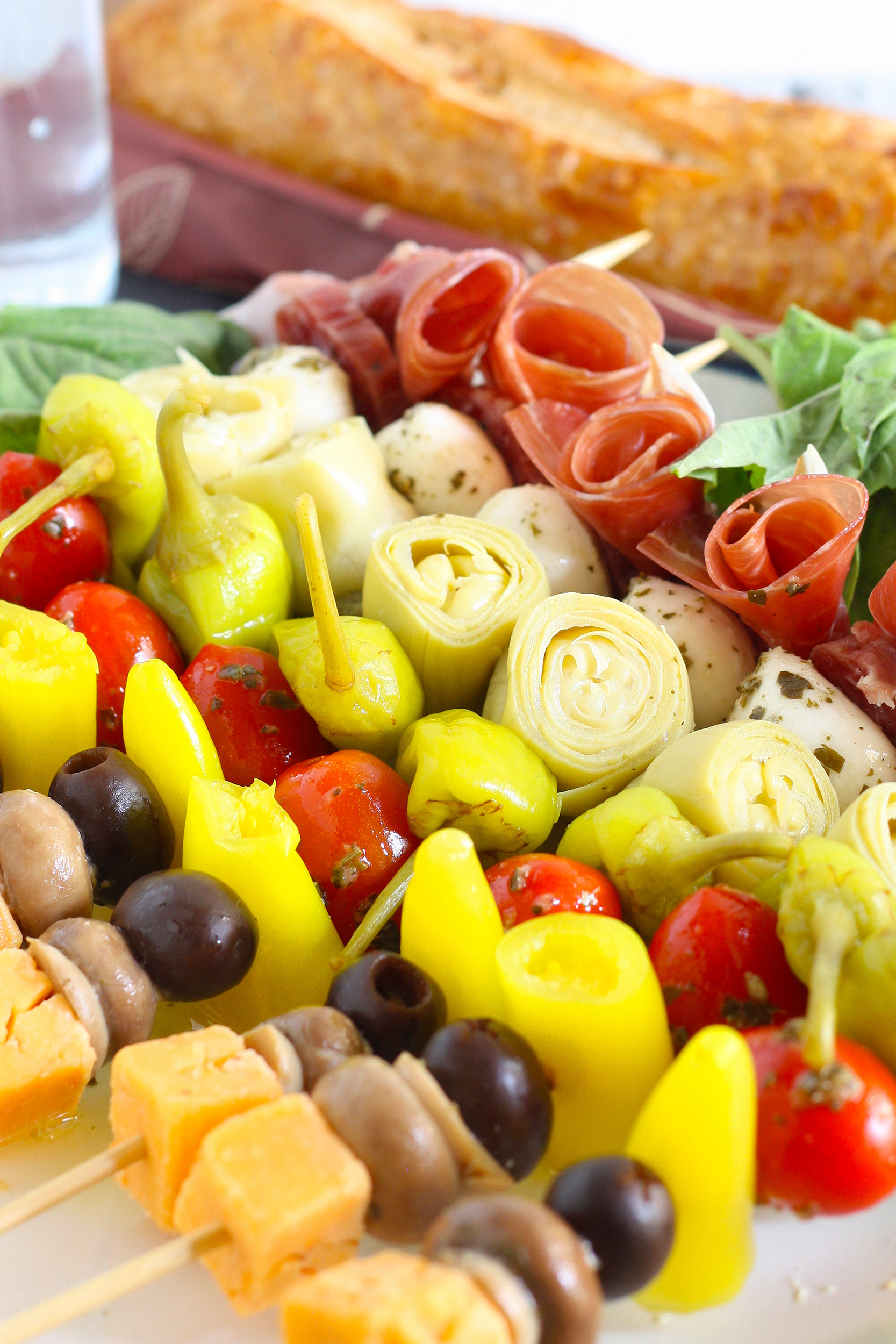 antipasti skewers with a loaf of bread