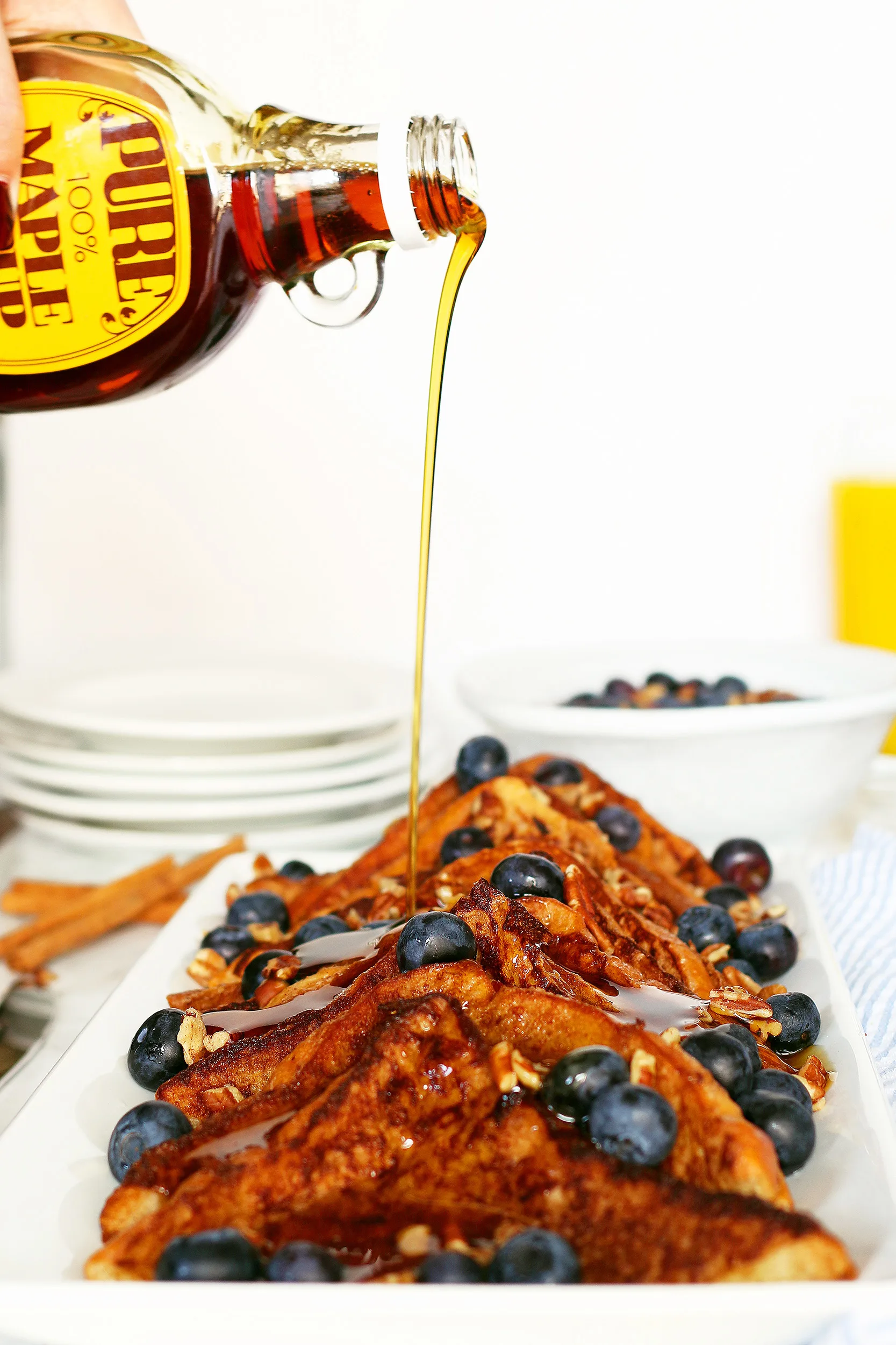 maple syrup being poured on top of French toast