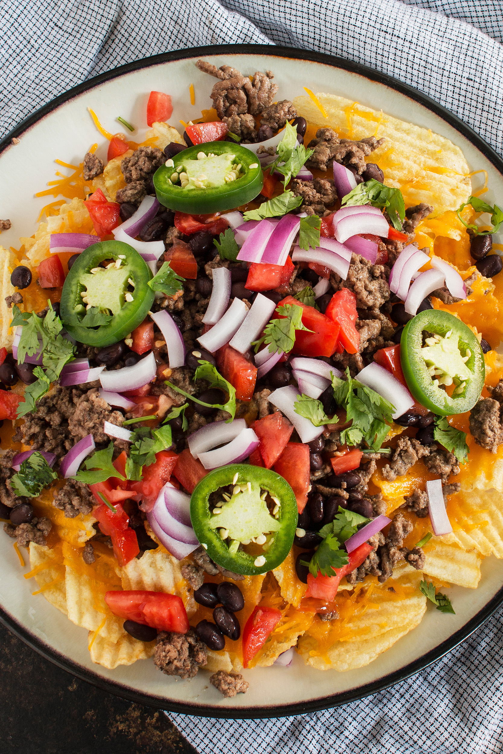 Irish nachos topped with jalapeños red onion ground beef cheese and black beans