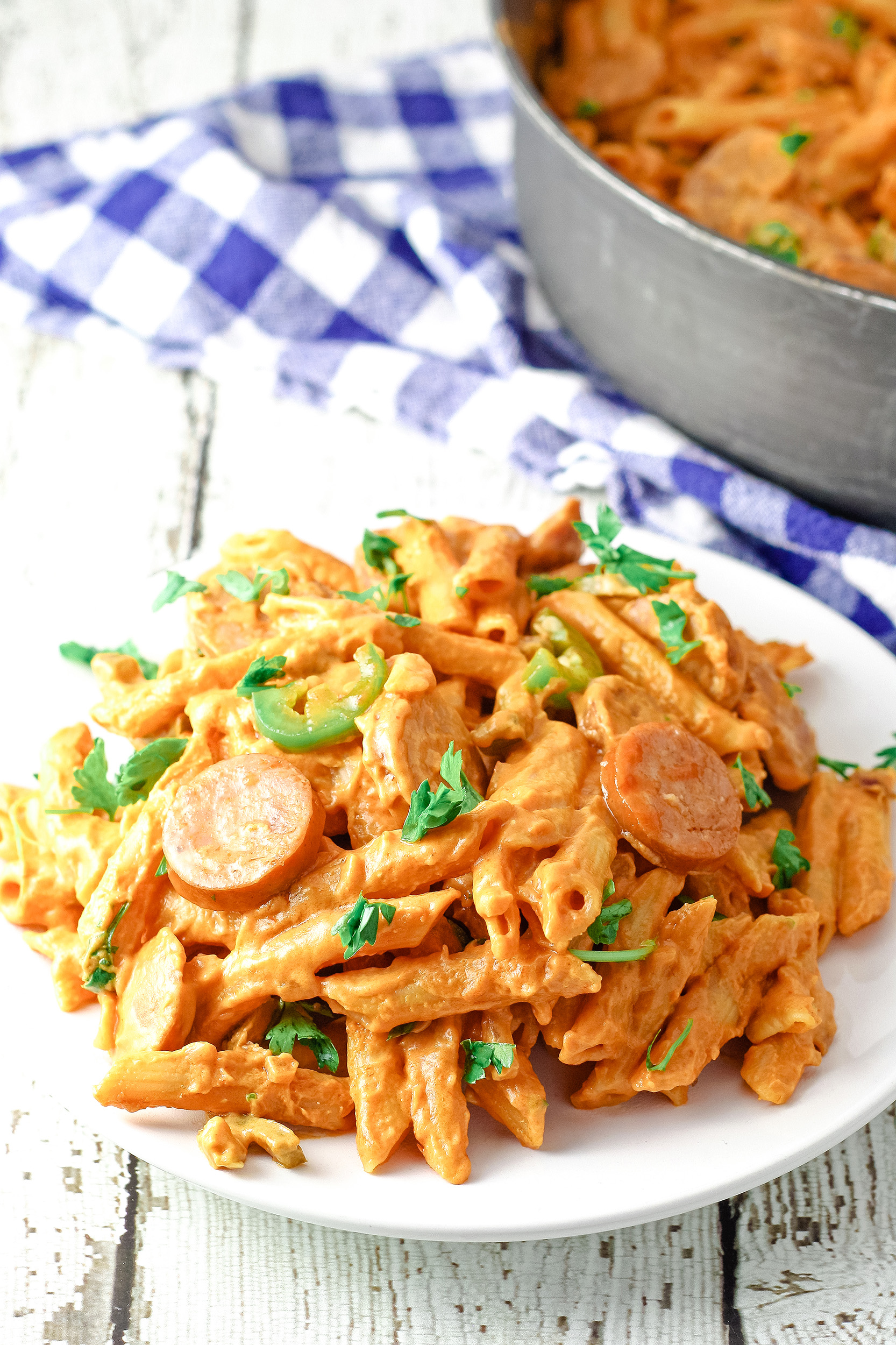 white plate full of spicy sausage pasta