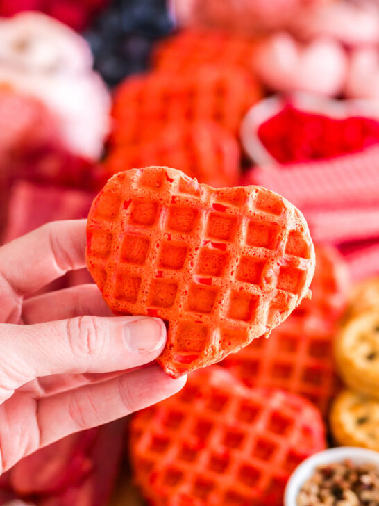 heart shaped strawberry waffle being held by a hand