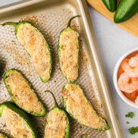 cooked stuffed shrimp jalapeño poppers on a sheet pan