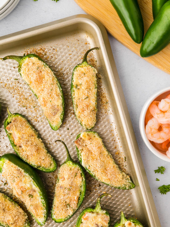 cooked stuffed shrimp jalapeño poppers on a sheet pan