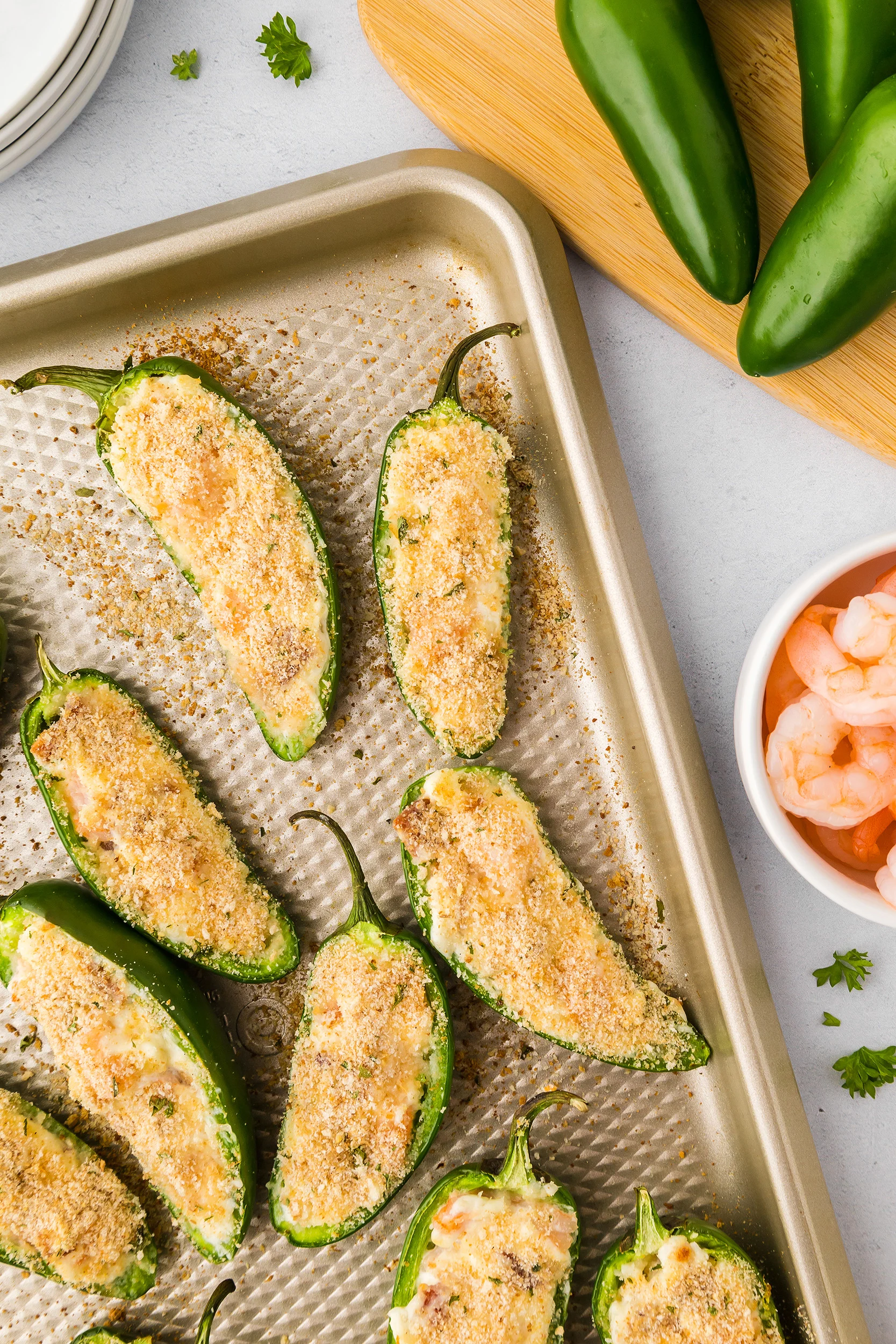 cooked stuffed shrimp jalapeño poppers on a sheet pan