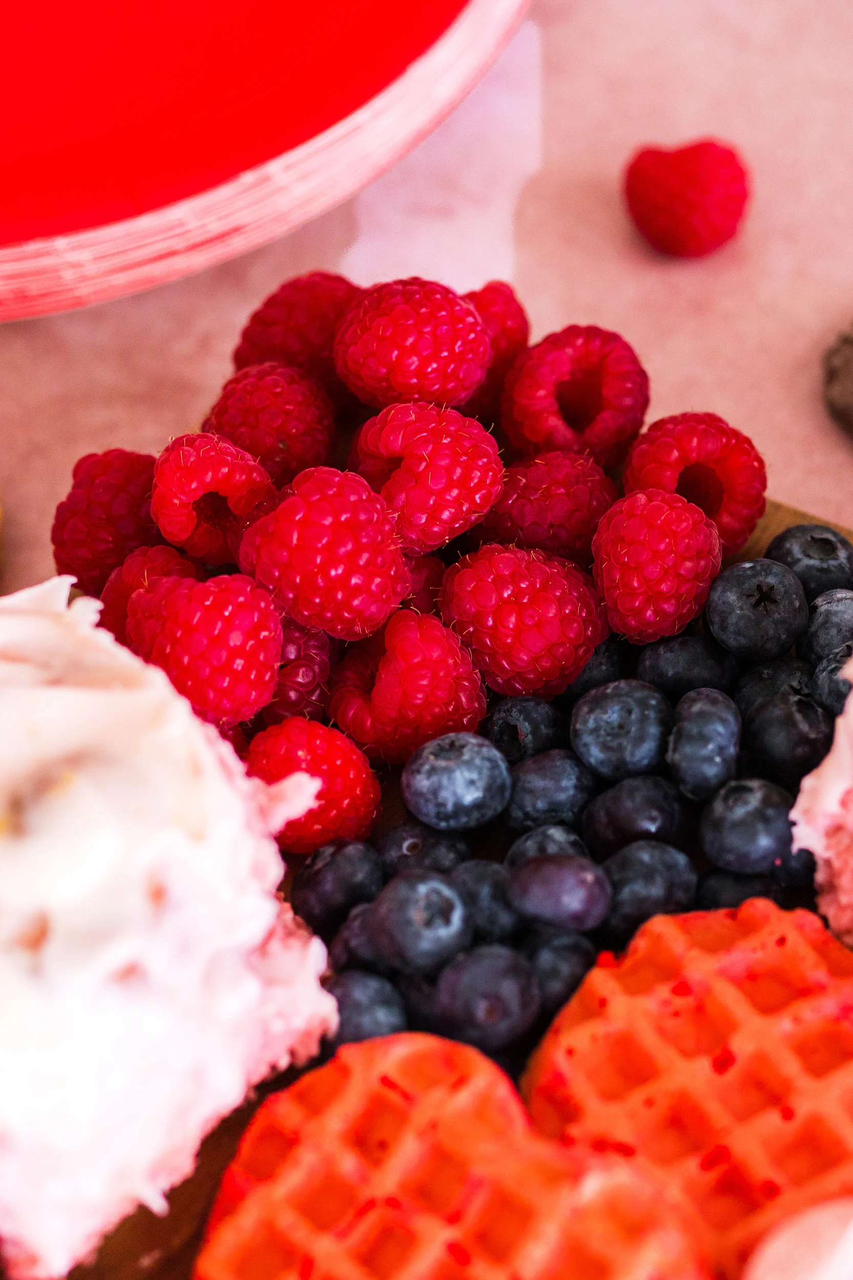 fresh berries - raspberries and blueberries in the corner of a breakfast board