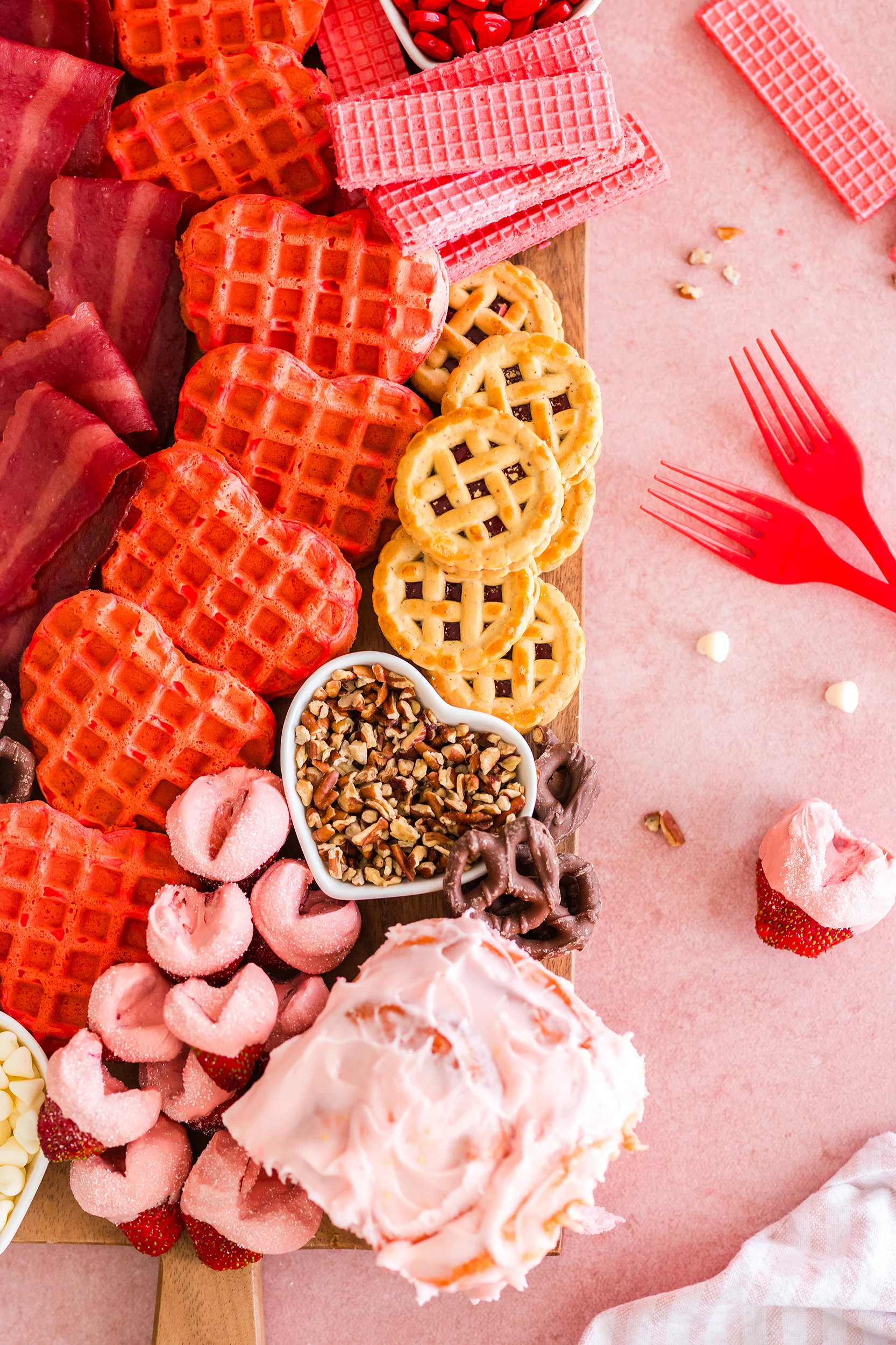 Valentine's Day breakfast charcuterie board on a pink background