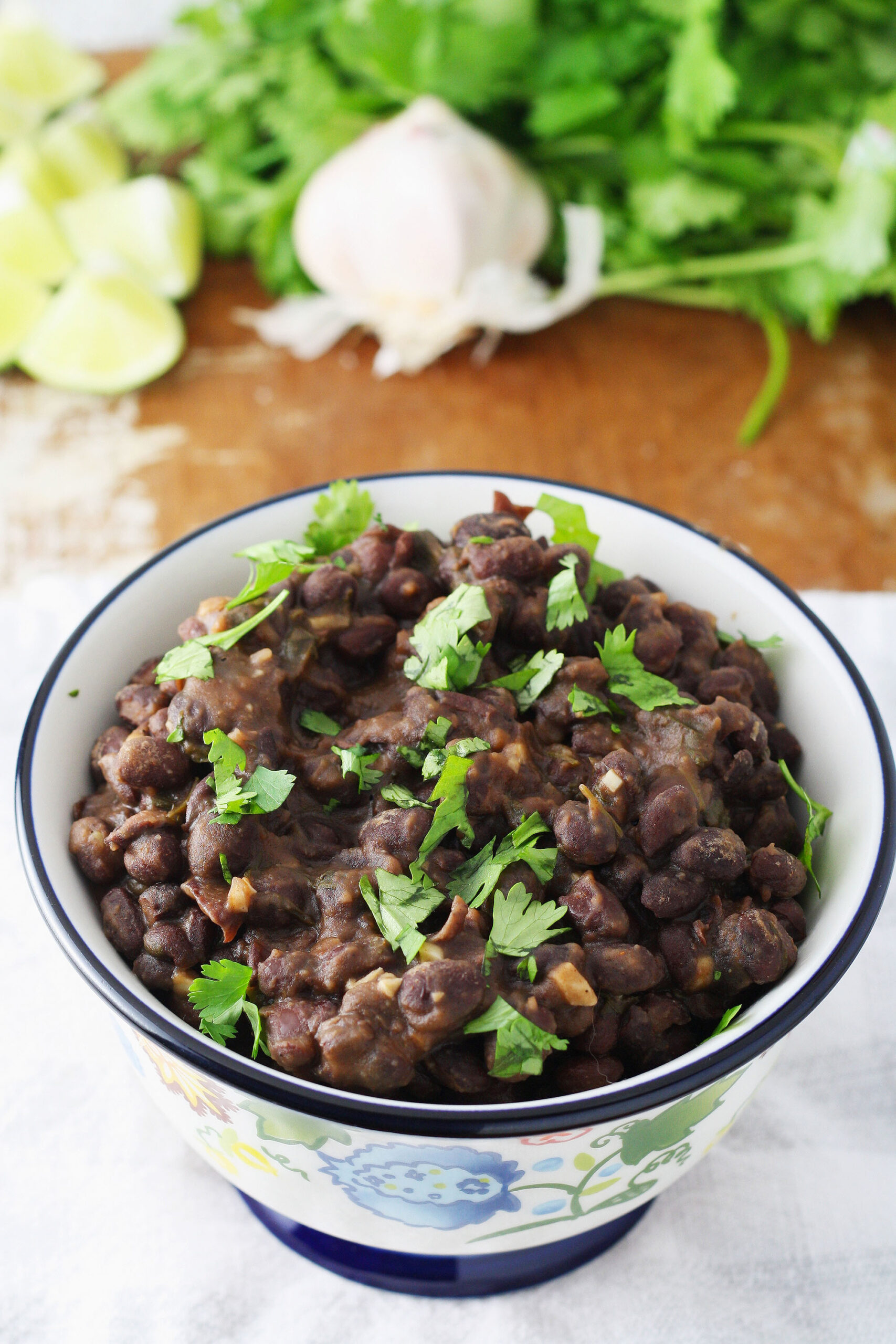 Mexican black beans in a bowl on a cutting board